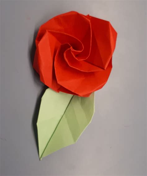 Origami Camellia Step 1: Start with a 6 inch square (15cm x 15cm) origami paper, color side down. Origami Camellia Step 2: Make 2 triangle folds, one along each diagonal axis. Crease well and unfold. Origami Camellia Step 3: Fold point A to meet the diagonal crease.